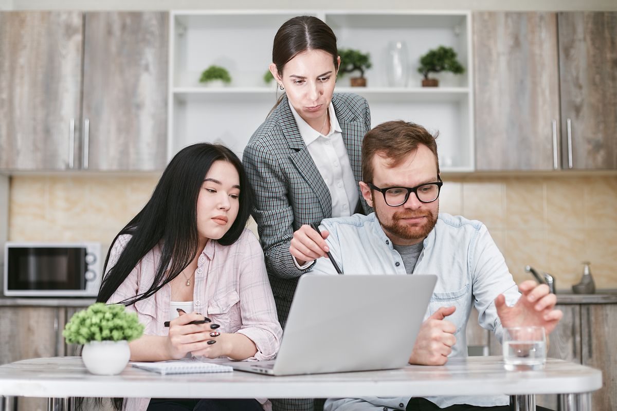 Three people working together at a table