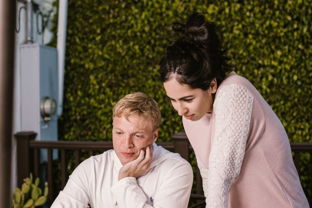 Two people looking at a screen together